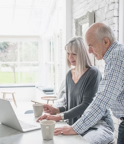 Older couple using a laptop at home